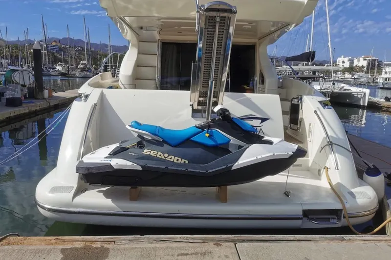 Chica Loca Yacht Photos Pics 2003 Azimut 55E yacht with Sea-Doo jet ski docked at marina.