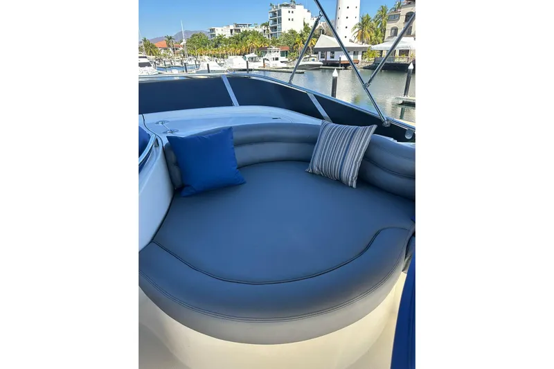 Chica Loca Yacht Photos Pics Luxurious seating area on 2003 Azimut 55E yacht with blue cushions and marina view.