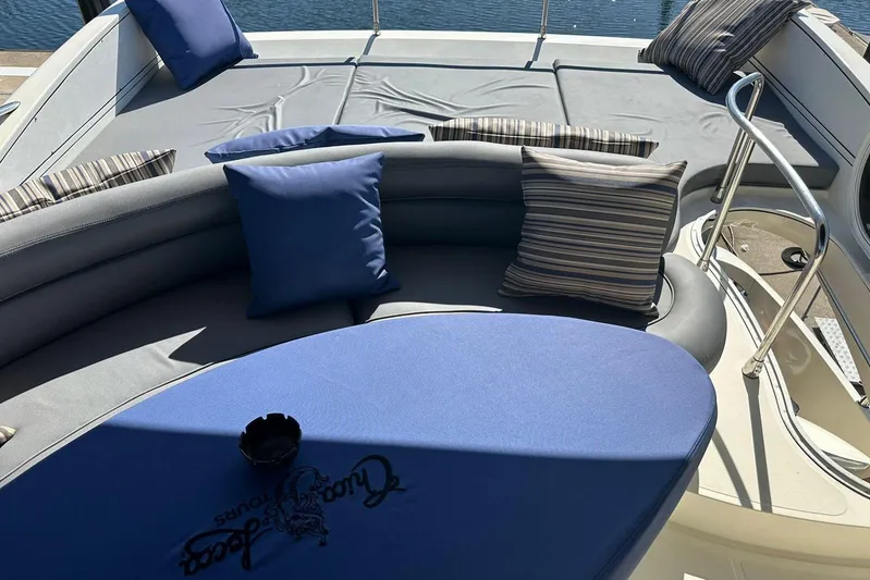 Chica Loca Yacht Photos Pics Luxurious seating area on 2003 Azimut 55E yacht with blue and striped cushions.