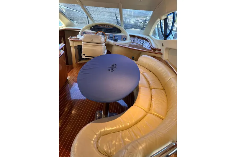 Chica Loca Yacht Photos Pics Luxurious interior of 2003 Azimut 55E yacht with leather seating and helm station.