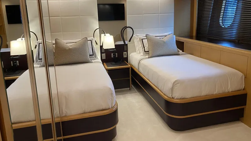 D'one Yacht Photos Pics Luxurious twin bedroom in a 2009 Leopard Yachts model, featuring modern decor and elegant lighting.