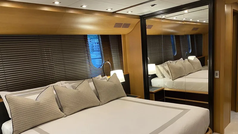 D'one Yacht Photos Pics Luxurious bedroom interior of 2009 Leopard Yachts, featuring elegant bedding and mirrored walls.