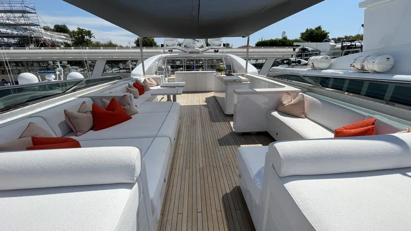 D'one Yacht Photos Pics Luxurious 2009 Leopard Yachts deck with white seating and red cushions under a canopy.