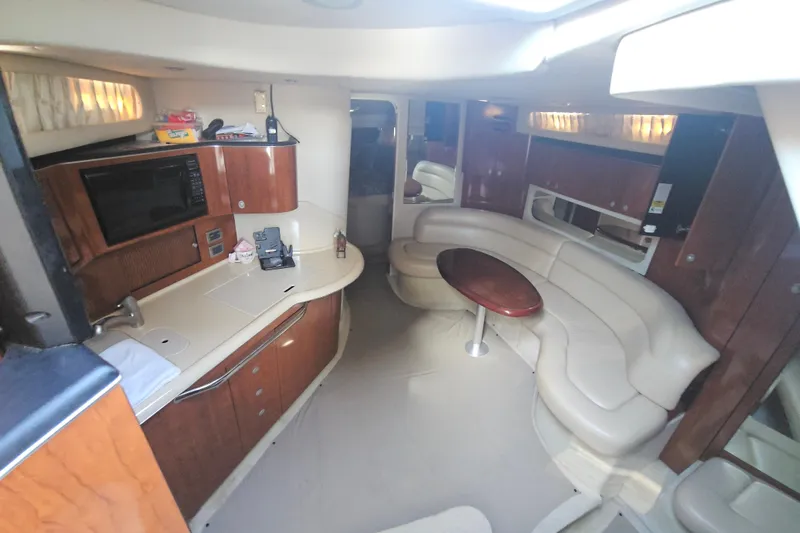 N/a Yacht Photos Pics 2004 Sea Ray 380 Sundancer interior with kitchenette and curved seating area.