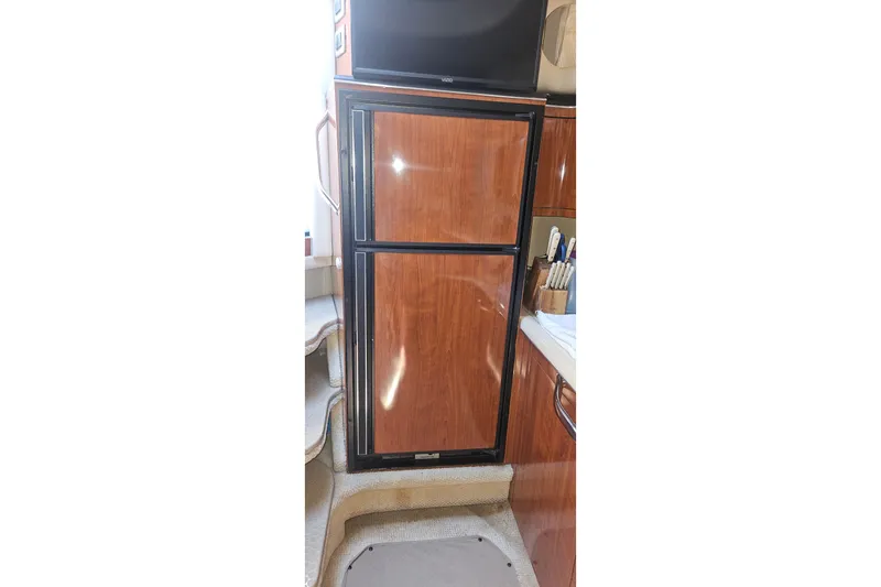 N/a Yacht Photos Pics 2004 Sea Ray 380 Sundancer interior with wooden cabinetry and compact refrigerator.