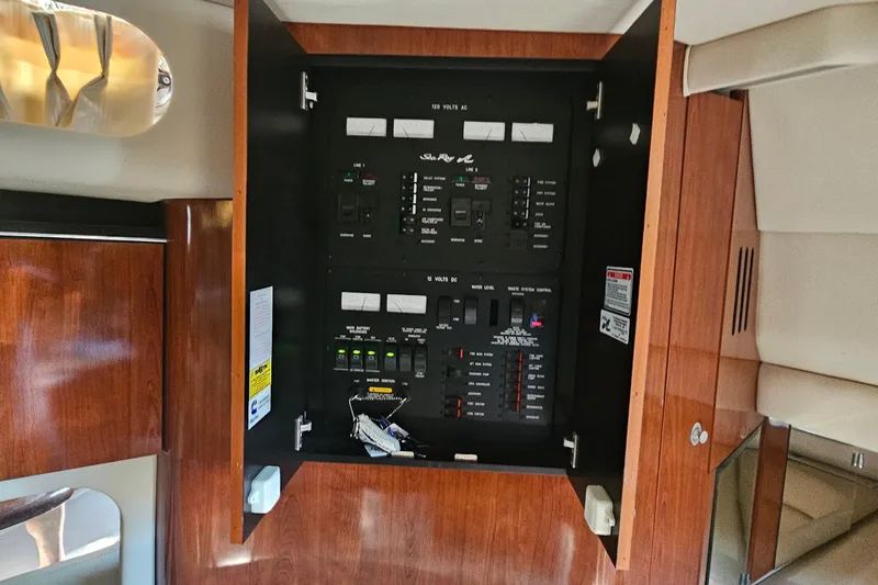 N/a Yacht Photos Pics Electrical panel inside 2004 Sea Ray 380 Sundancer yacht, featuring wood cabinetry.