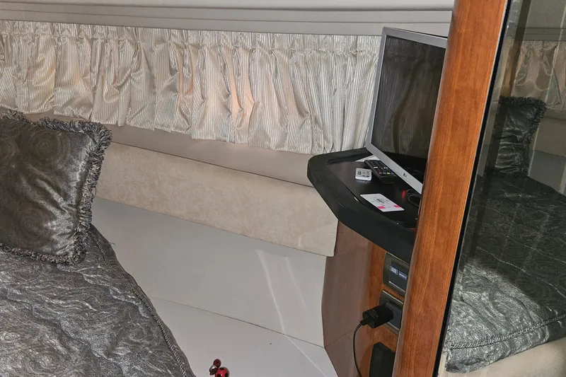 N/a Yacht Photos Pics Interior cabin of 2004 Sea Ray 380 Sundancer with TV and elegant bedding.