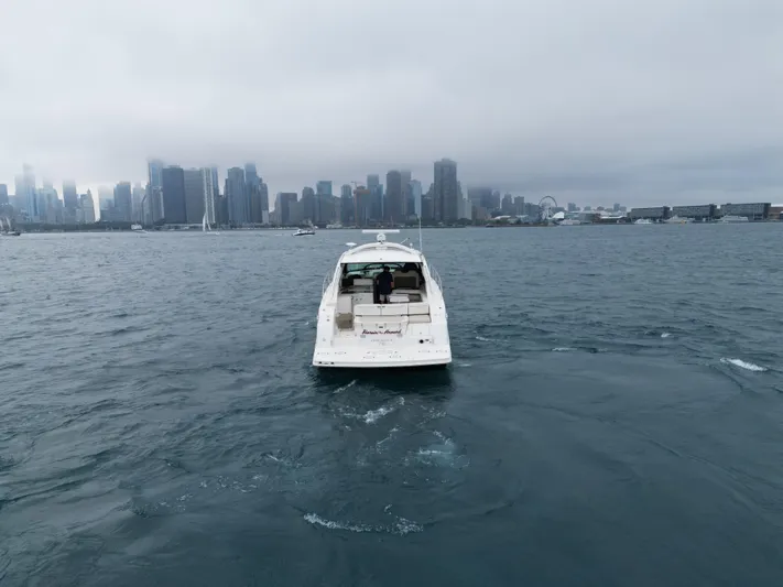 Cabby 13 Yacht Photos Pics 2013 Sea Ray 470 Sundancer yacht on water with city skyline in background.
