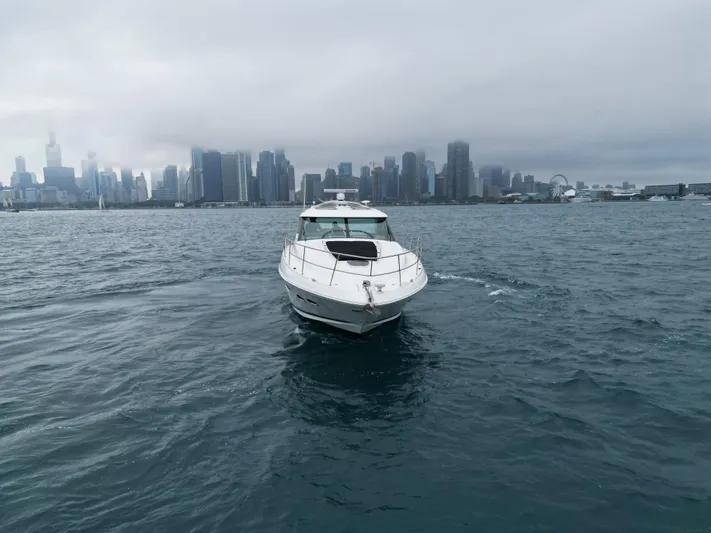 Cabby 13 Yacht Photos Pics 2013 Sea Ray 470 Sundancer yacht on water with city skyline in background.