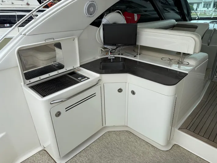 Cabby 13 Yacht Photos Pics 2013 Sea Ray 470 Sundancer yacht kitchenette with grill, sink, and storage cabinets.