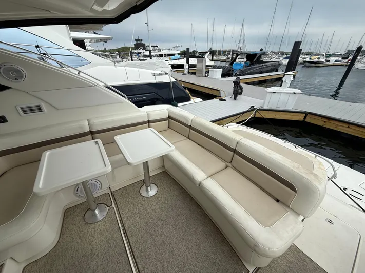 Cabby 13 Yacht Photos Pics 2013 Sea Ray 470 Sundancer yacht with spacious seating and tables at marina.
