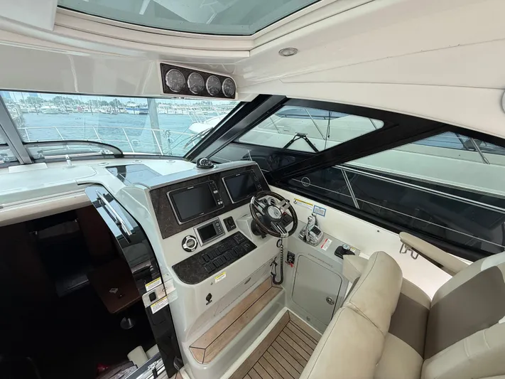 Cabby 13 Yacht Photos Pics Interior cockpit of 2013 Sea Ray 470 Sundancer yacht with modern controls and seating.