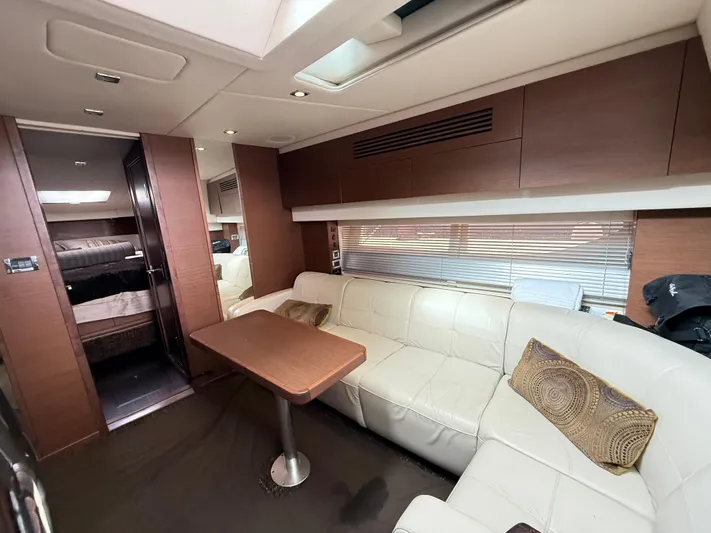 Cabby 13 Yacht Photos Pics Luxurious interior of 2013 Sea Ray 470 Sundancer yacht with leather seating and wooden accents.