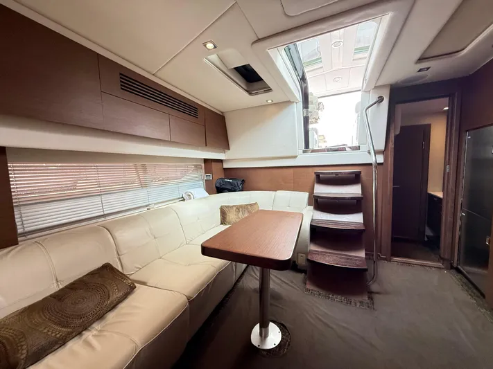 Cabby 13 Yacht Photos Pics Luxurious interior of 2013 Sea Ray 470 Sundancer yacht with elegant seating and wooden accents.