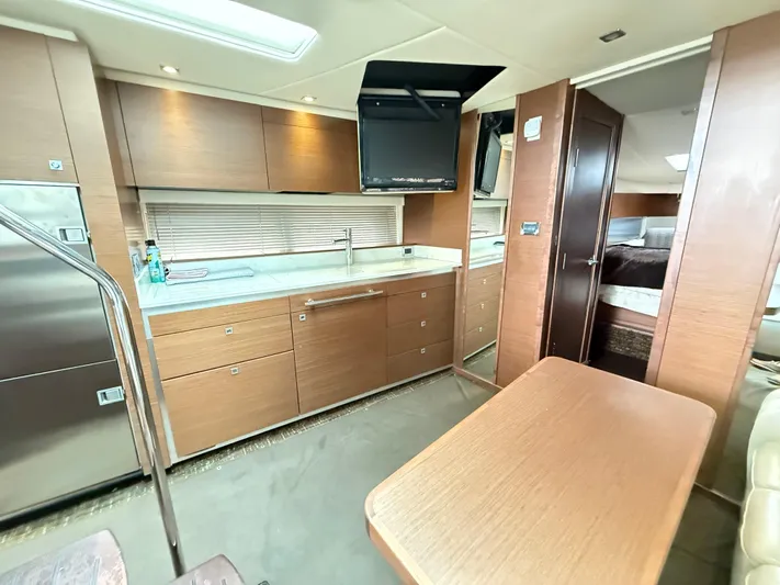 Cabby 13 Yacht Photos Pics Luxurious interior of 2013 Sea Ray 470 Sundancer yacht with modern kitchen and dining area.