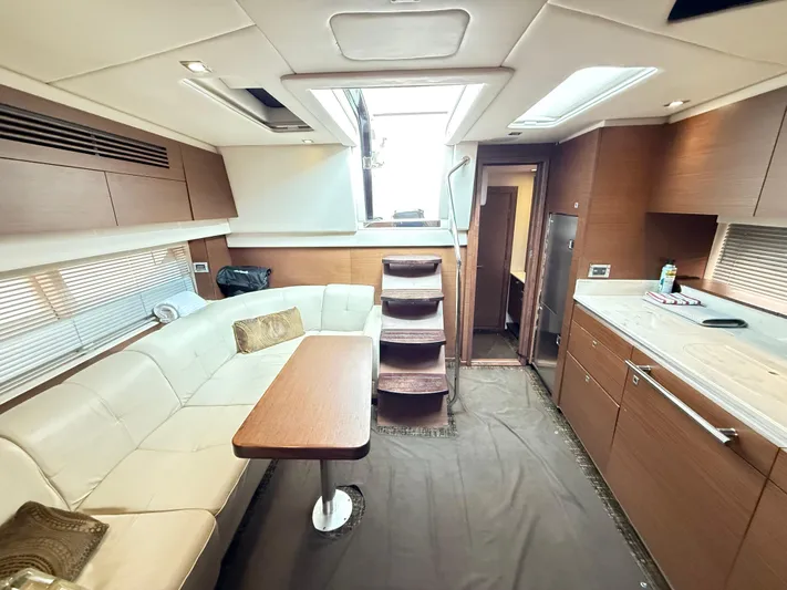 Cabby 13 Yacht Photos Pics Luxurious interior of 2013 Sea Ray 470 Sundancer yacht with modern seating and kitchen area.