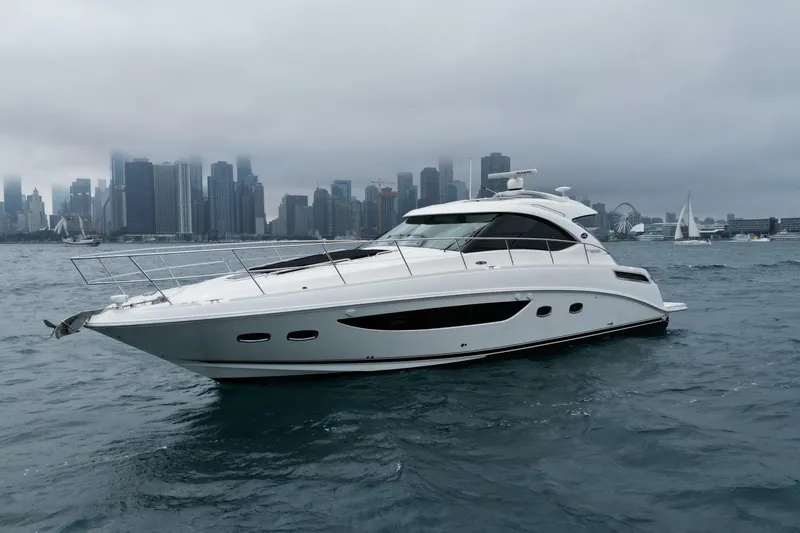 Cabby 13 Yacht Photos Pics 2013 Sea Ray 470 Sundancer yacht on water with city skyline background.