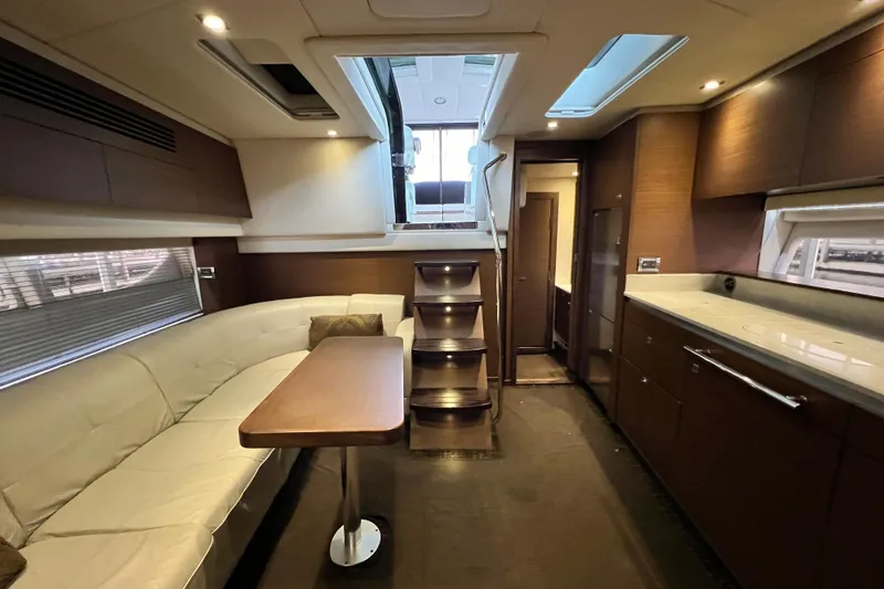 Cabby 13 Yacht Photos Pics Luxurious interior of 2013 Sea Ray 470 Sundancer yacht with modern seating and kitchen area.