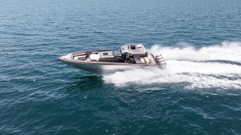  Yacht Photos Pics 2025 Cigarette 42 Auroris speedboat cruising on open water.