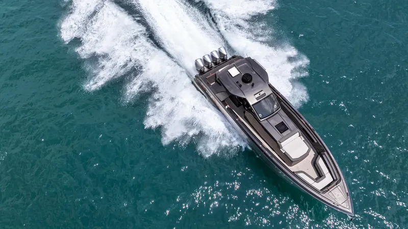  Yacht Photos Pics Aerial view of 2025 Cigarette 42 Auroris speedboat cruising on turquoise water.