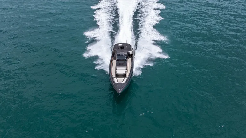  Yacht Photos Pics 2025 Cigarette 42 Auroris speedboat cruising on open water, aerial view.