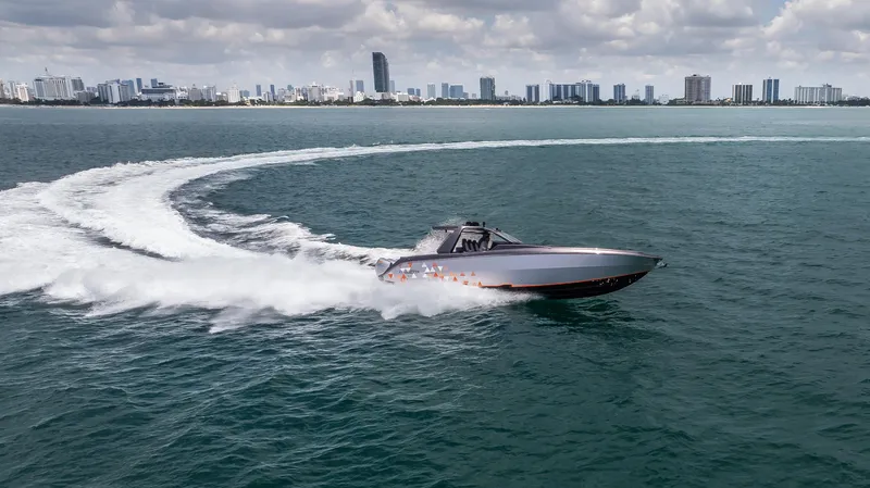  Yacht Photos Pics 2025 Cigarette 42 Auroris speedboat cruising on open water with city skyline in background.