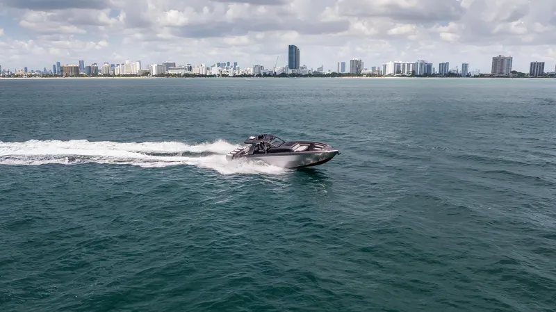  Yacht Photos Pics 2025 Cigarette 42 Auroris speedboat cruising on ocean near city skyline.