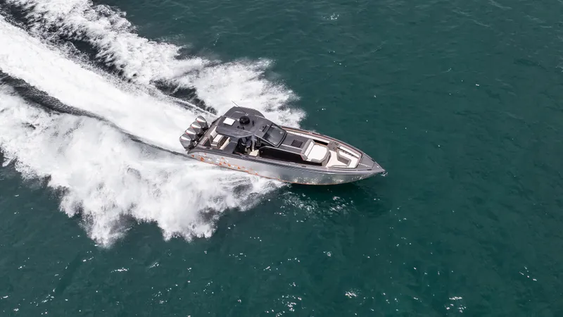  Yacht Photos Pics 2025 Cigarette 42 Auroris speedboat cruising on open water, creating a dynamic wake.