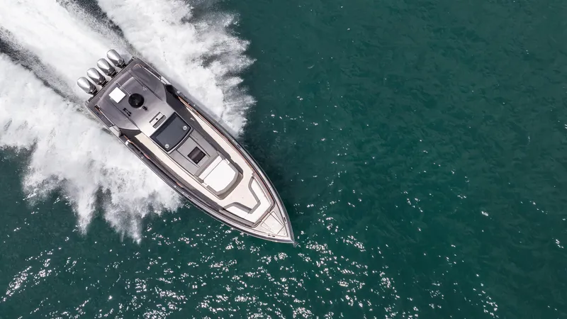  Yacht Photos Pics Aerial view of 2025 Cigarette 42 Auroris speedboat cruising on open water.