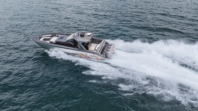  Yacht Photos Pics 2025 Cigarette 42 Auroris speedboat cruising swiftly on open water.