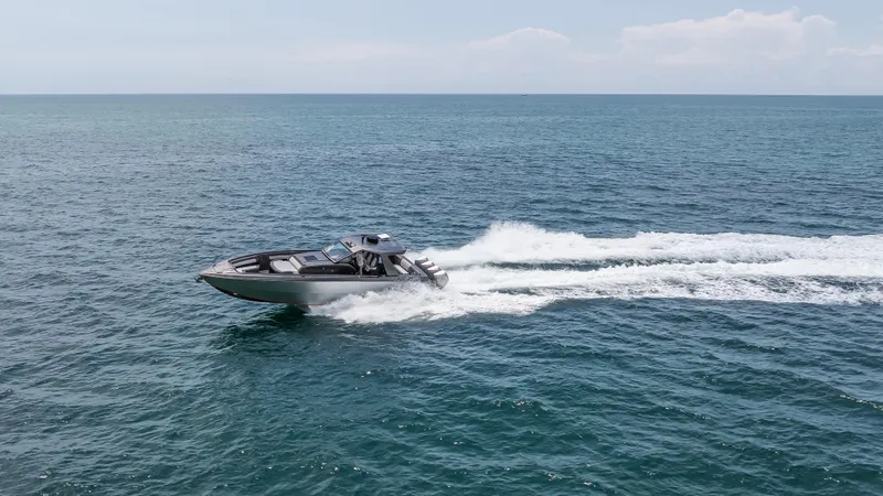  Yacht Photos Pics 2025 Cigarette 42 Auroris speedboat cruising on open ocean waters.