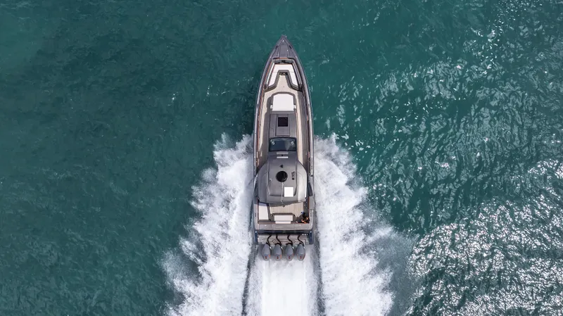  Yacht Photos Pics Aerial view of 2025 Cigarette 42 Auroris speedboat cruising on turquoise water.