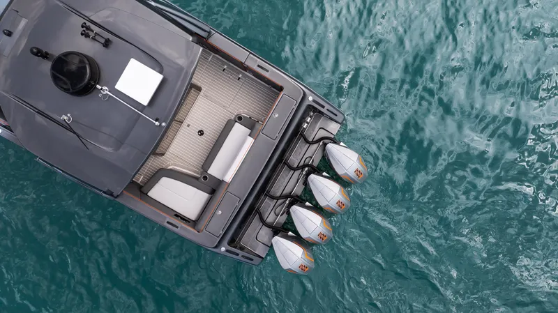  Yacht Photos Pics Aerial view of 2025 Cigarette 42 Auroris boat with triple outboard engines on blue water.