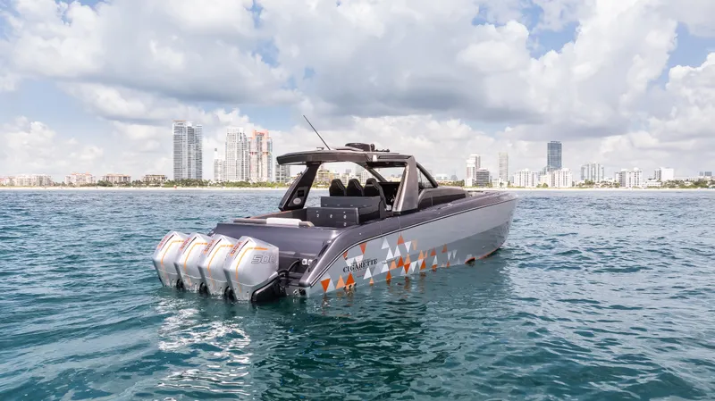  Yacht Photos Pics 2025 Cigarette 42 Auroris boat on water with city skyline in background.