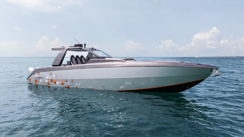  Yacht Photos Pics 2025 Cigarette 42 Auroris boat on calm ocean waters under clear sky.