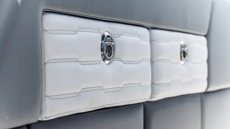  Yacht Photos Pics Luxury interior detail of 2025 Cigarette 42 Auroris boat, featuring sleek white and gray upholstery.