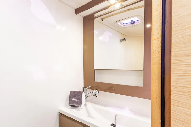  Yacht Photos Pics 2019 Fountaine Pajot MY 37 yacht bathroom with mirror, sink, and towel.