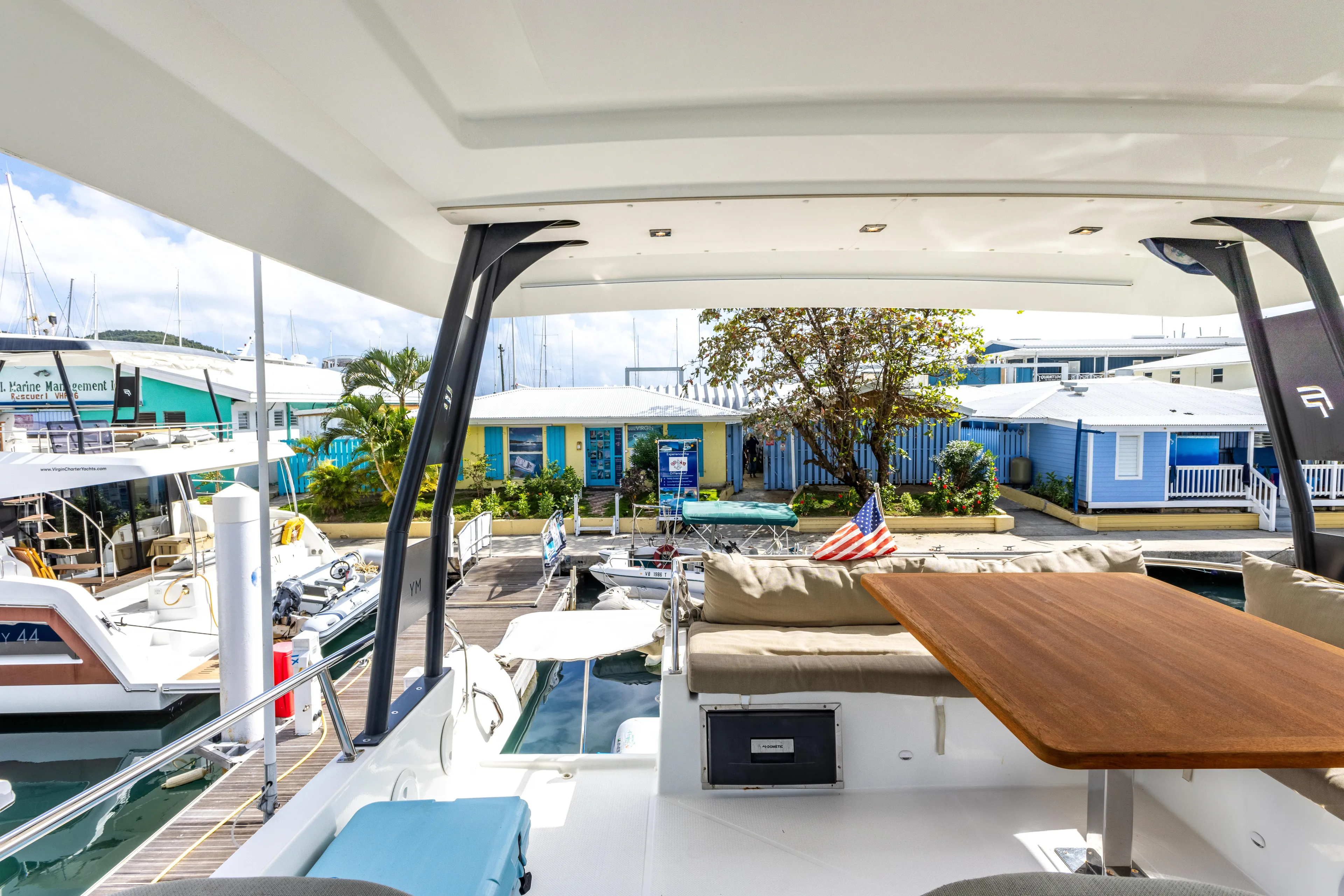  Yacht Photos Pics 2019 Fountaine Pajot MY 37 yacht with outdoor seating and table at marina.