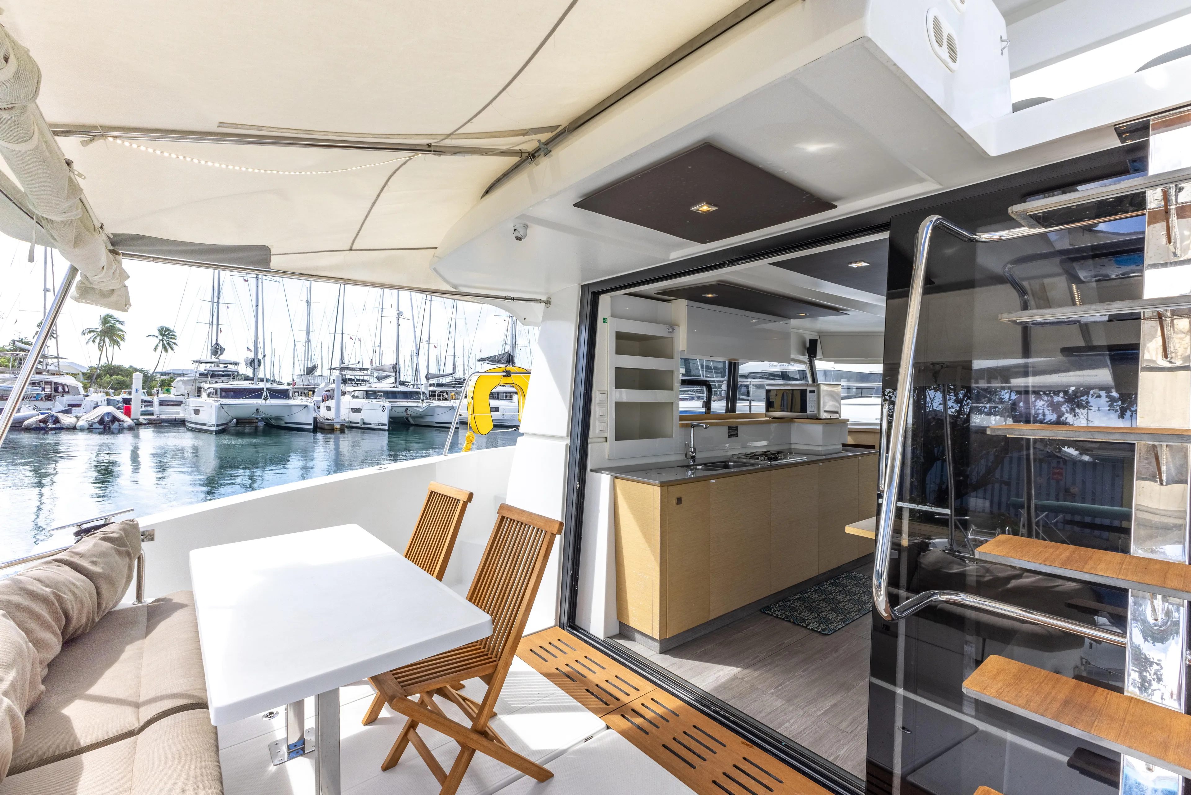  Yacht Photos Pics 2019 Fountaine Pajot MY 37 yacht interior with dining area and marina view.