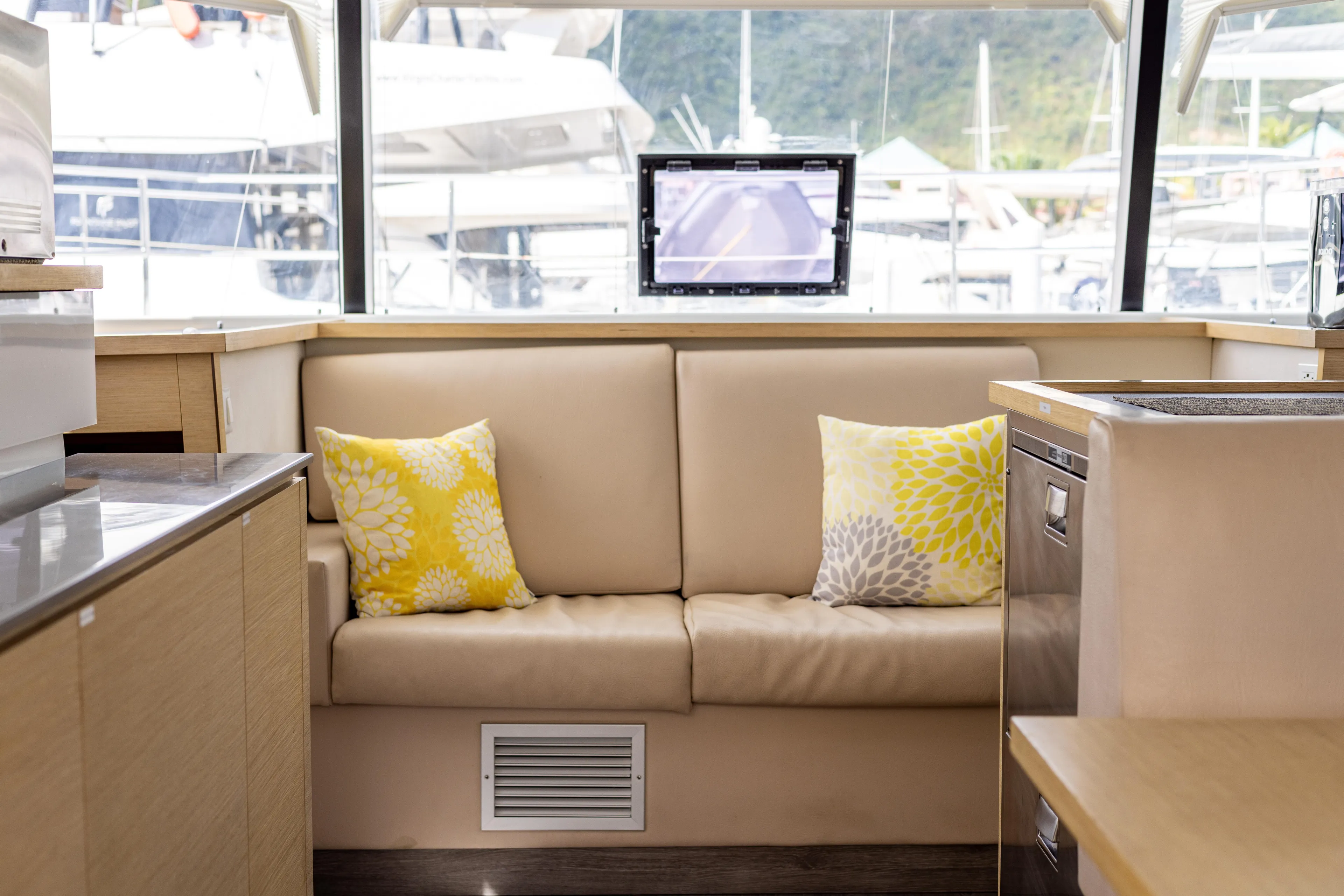  Yacht Photos Pics Interior of 2019 Fountaine Pajot MY 37 yacht with beige sofa and decorative pillows.
