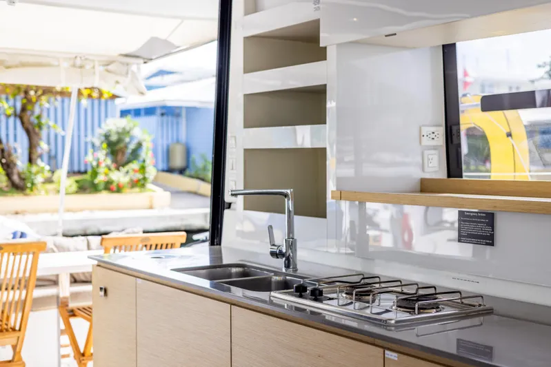  Yacht Photos Pics Modern kitchen interior on 2019 Fountaine Pajot MY 37 yacht, featuring stove and sink.