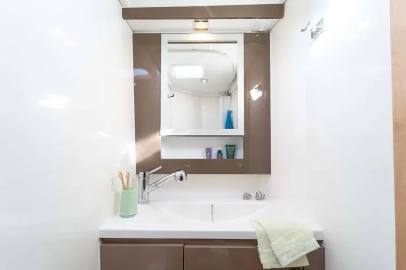  Yacht Photos Pics Modern bathroom interior of 2019 Fountaine Pajot MY 37 yacht with mirror and sink.