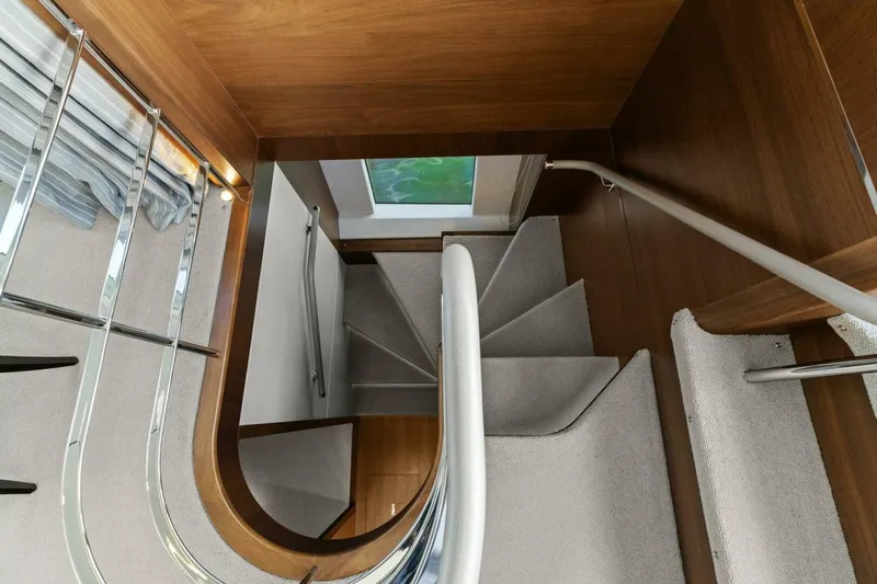 Amarula Sun Yacht Photos Pics Staircase inside 2018 Princess Y75 Motor Yacht with wooden and carpeted steps.