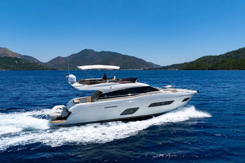Dudu Yacht Photos Pics 2021 Ferretti Yachts 550 cruising on blue ocean with scenic mountain backdrop.