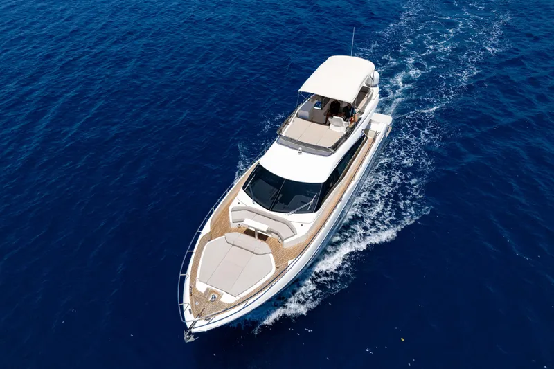 Dudu Yacht Photos Pics 2021 Ferretti Yachts 550 cruising on open blue sea, aerial view.