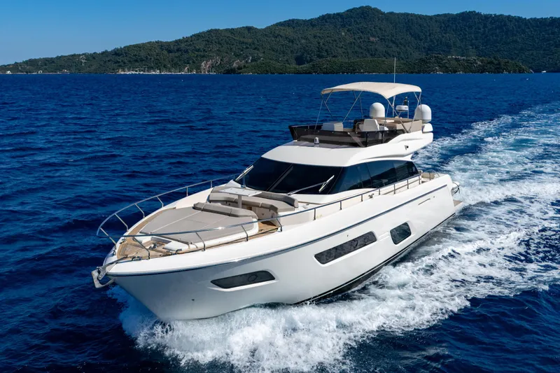 Dudu Yacht Photos Pics 2021 Ferretti Yachts 550 cruising on blue ocean with scenic island backdrop.