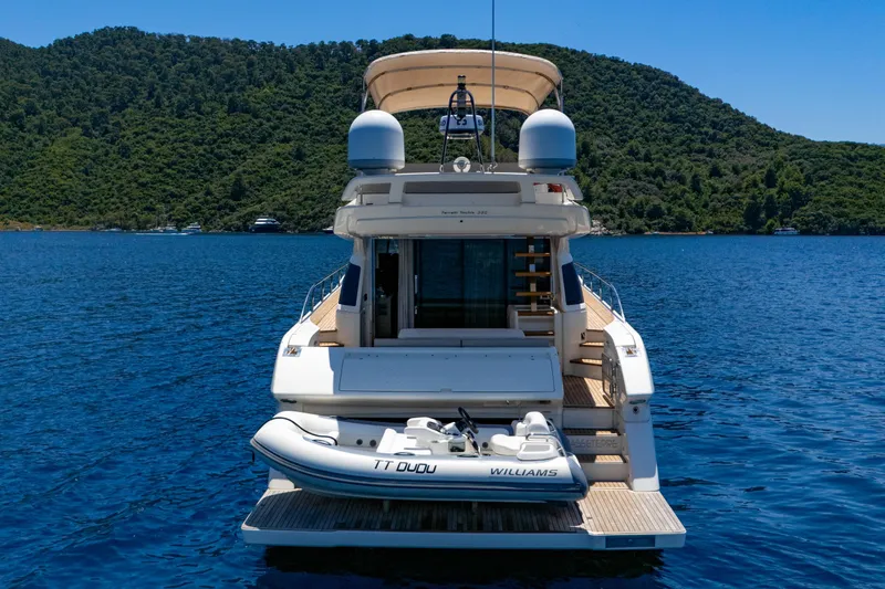 Dudu Yacht Photos Pics 2021 Ferretti Yachts 550 on serene water with lush green hills in the background.