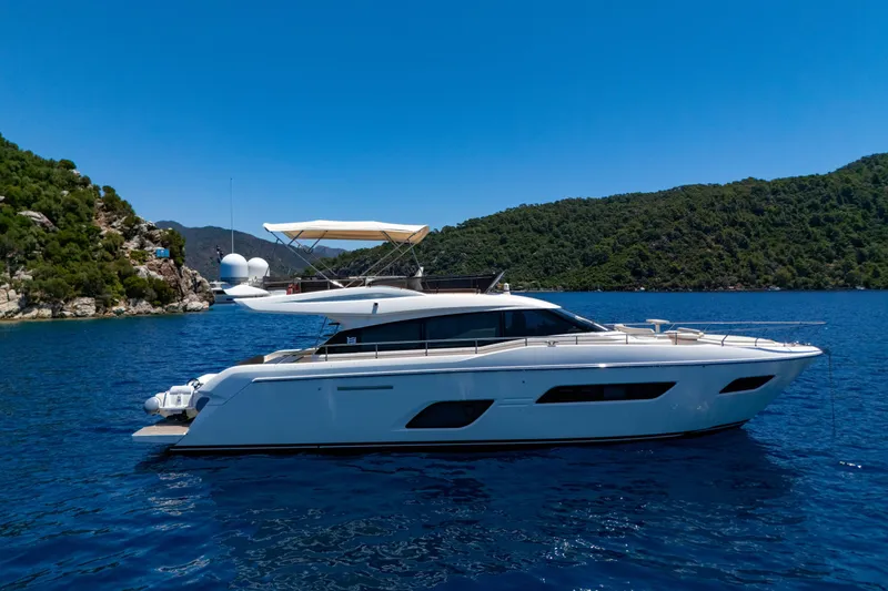 Dudu Yacht Photos Pics 2021 Ferretti Yachts 550 cruising on blue waters near lush green hills.