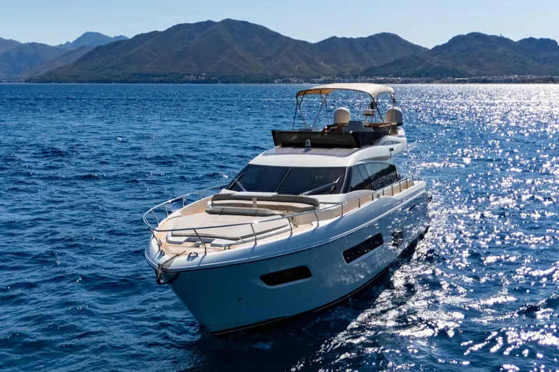 Dudu Yacht Photos Pics 2021 Ferretti Yachts 550 cruising on blue ocean with scenic mountain backdrop.