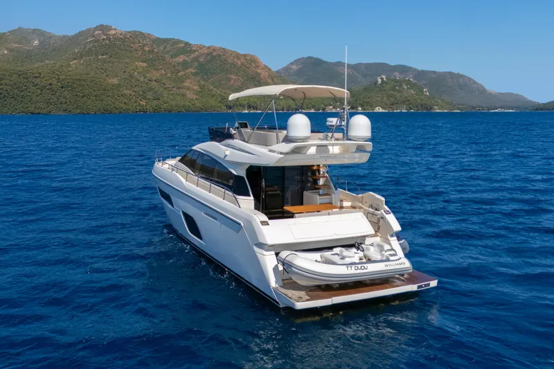 Dudu Yacht Photos Pics Ferretti Yachts 550, 2021 model, cruising on blue waters with scenic mountain backdrop.